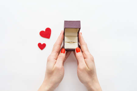 girl holding a box with a ring with a diamond in her hands. Marriage proposalsの写真素材