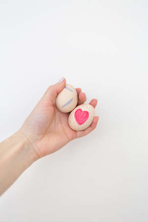 Girl holding Easter eggs painted with watercolors in hands, isolated on white backgroundの写真素材