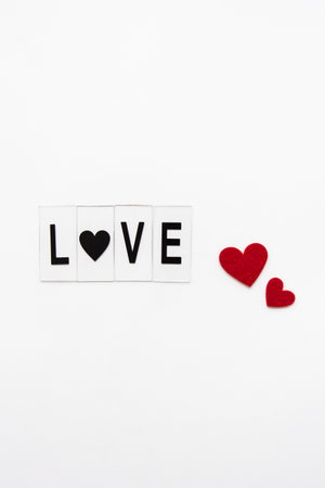 Beautiful inscription love on a white background, small red hearts. Postcardの写真素材
