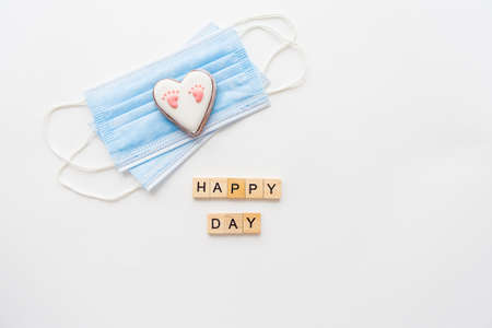 Disposable medical mask and two hearts. Heart with baby footprint.