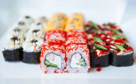 Sushi from Japanese cuisine. There are different types of sushi in the box. Delicious and healthy food delivery concept. Close-upの写真素材