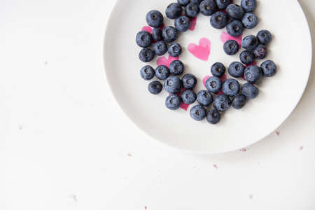 Juicy, tasty, ripe strawberries on a plate, top view. Vertical photo. Place for an inscriptionの写真素材