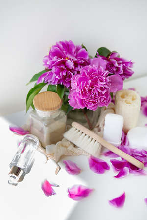 Green lifestyle concept, zero waste. Natural cosmetic. Natural deodorant, loofah, reusable bags on the background of peonies. Stop plastic pollutionの写真素材
