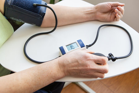 Measurement of blood pressure. The woman measures blood pressure. Self-diagnosis at homeの写真素材