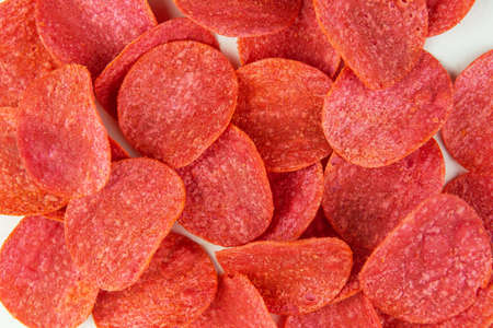 Red chips with hot pepper taste on a white background. Beer snack. Close-upの写真素材