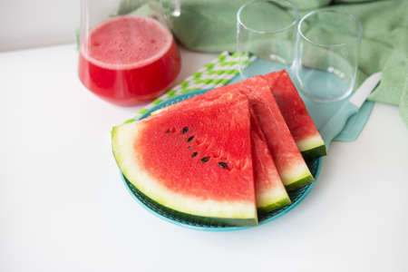 The process of making freshly squeezed juice from fresh watermelon, a healthy smoothie made from watermelon and mint leaves. A refreshing summer cocktailの写真素材