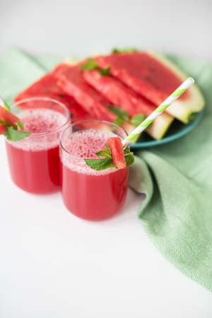 A glass of freshly squeezed fresh watermelon juice, a healthy watermelon and mint leaf smoothieの写真素材