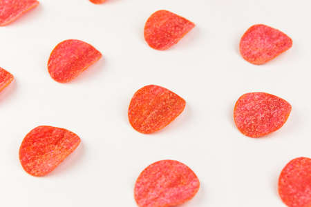 Tortilla chips pattern on a red background. Repetition concept. Top viewの写真素材