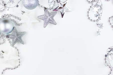 Festive mood, preparation for the holiday. New Year's festive decor in silvery colors - toys, star, round balls, place for an inscription. View from aboveの写真素材