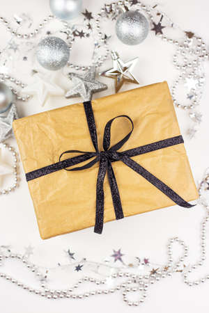 Very nice festive decor. A Christmas gift craft box lies in the center along with a festive silver-toned decorの写真素材