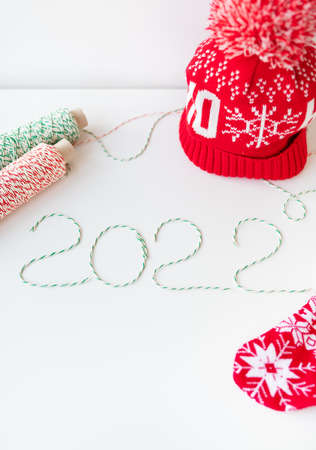 Holiday concept for Christmas and New Year 2022. Layout of various Christmas attributes - hat, sock, striped threads for packagingの写真素材