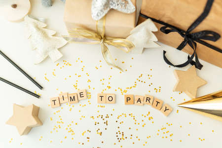 Christmas party time - confetti, gifts, tree, stars, glitter, ribbon. Party time lettering. New year 2022 Top view bannerの写真素材