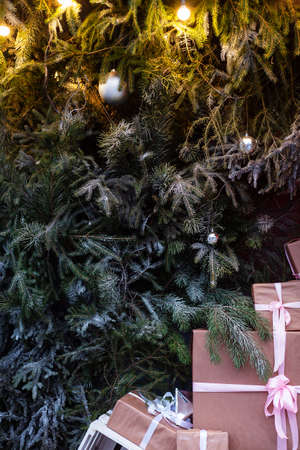 Craft gift boxes on the street near the Christmas tree.Christmas and new year conceptの写真素材