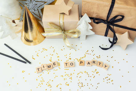 Christmas party time - confetti, gifts, ribbon, stars. Party time lettering. New year 2022の写真素材