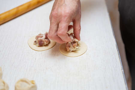 Cooking process. Manti is a very popular recipe in most cuisines, similar to dumplings made from pork, beef, lamb in the countries of the South Caucasus, Georgia, Russia, Afghanistan, and Central Asia in generalの写真素材
