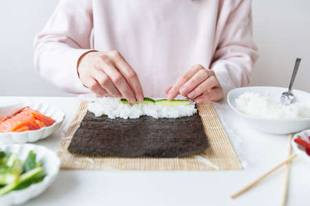 Sushi cooking process, girl makes sushi with different flavorsの素材 [FY310180273013]