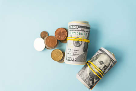 International money dollar bills, coins lie next to money twisted rubber bands. Place for an inscriptionの写真素材