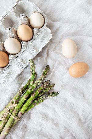 Asparagus and eggs on a fabric linen background. The concept of a healthy and healthy breakfast....