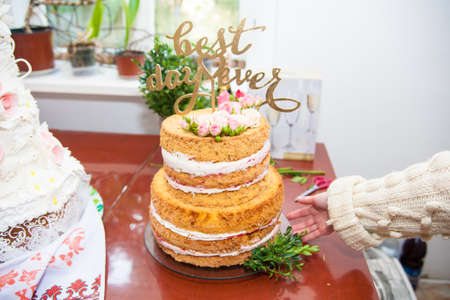 big beautiful wedding cake with fresh rosesの写真素材