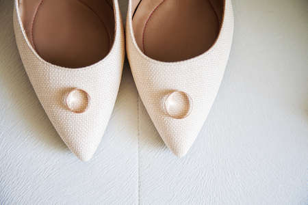 Beautiful beige wedding shoes and wedding ringsの写真素材