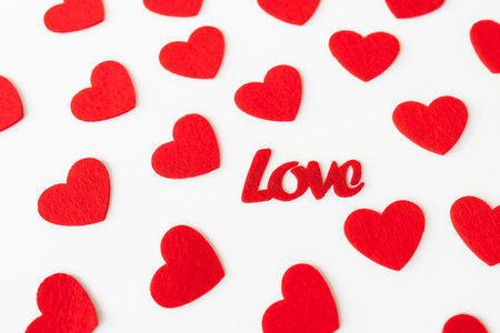The background which consists of red hearts, the inscription love in the middle of the hearts. Love concept, greeting card for valentine's dayの写真素材