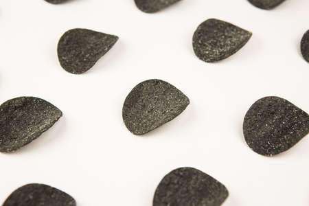 Drawing of black chips on a white background. The concept of repetition. View from aboveの写真素材