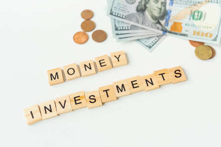 International currency money including euro, dollar, coin, dollar bill. The inscription in wooden letters money investments. The concept of investments, loans, debtsの写真素材