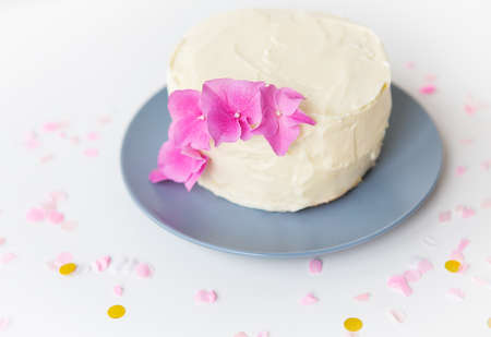 Very beautiful small white bento cake, decorated with fresh flowers of pink hydrangeas. holiday and fun conceptの写真素材