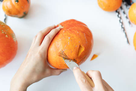 Halloween October 31st. The step by step process of carving a pumpkin. View from aboveの写真素材