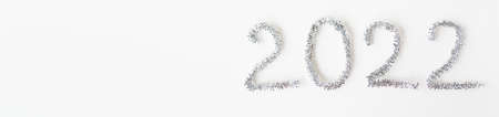Baner happy new year 2022 written with foil and new year rain on an isolated white background. happy new year greetingsの写真素材