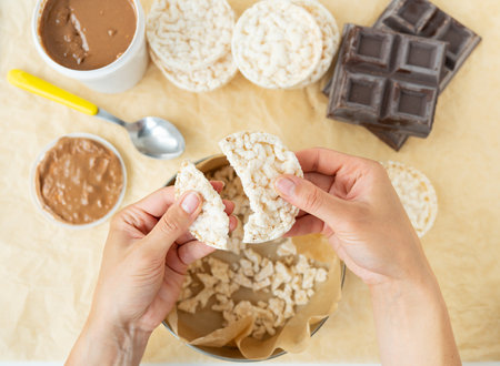 Top view of the process of preparing a delicious dessert peanut butter along with rice cakes. Vegan dessert, tasty and healthyの写真素材