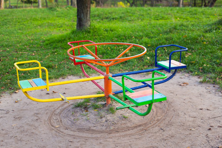 A bright playground surrounded by greenery, many different children's swings, a beautiful and cozy park for relaxationの写真素材