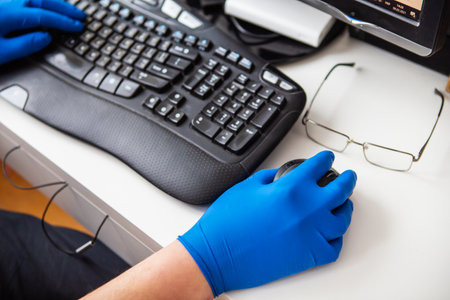 A doctor in blue gloves quickly collects data about a patient. The concept of healthcare and taking care of your health. Doctor's workplaceの写真素材
