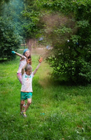 Lviv, Ukraine - July 18, 2021: Color Holi Festival, boy and girl throw colored paint. The holiday comes from Indiaのeditorial素材