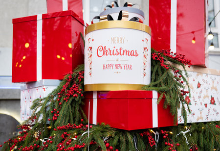 Against the background of a Christmas tree and decorations, there are many large, bright and beautiful red gift boxes. Christmas and New Year 2023-2024の写真素材