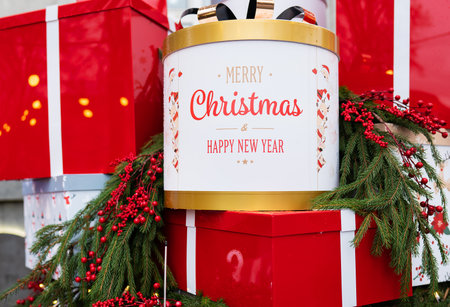 Against the background of a Christmas tree and decorations, there are many large, bright and beautiful red gift boxes. Christmas and New Year 2023-2024の写真素材