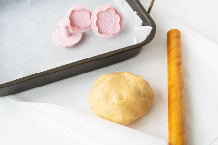 Preparation of dough for making cookies with molds in the form of flowers, a rolling pin and a baking sheet, Concept of cooking food baking at homeの写真素材