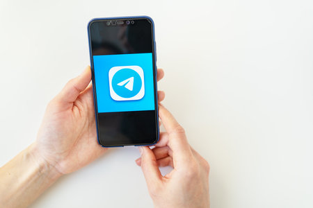 Rivne, Ukraine - December 13, 2022: Telegram mobile application icon on iPhone smartphone screen macro. Telegram is a cross-platform messengerのeditorial素材