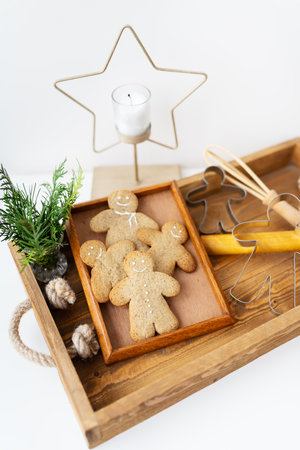 Gingerbread Man. Cooking gingerbread at home lies on a wooden tray. holiday conceptの写真素材
