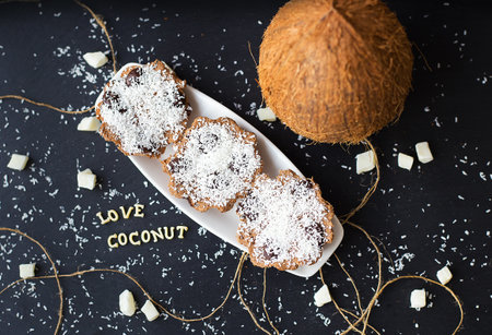coconut muffins on a black background with words like candied fruits and coconutsの写真素材