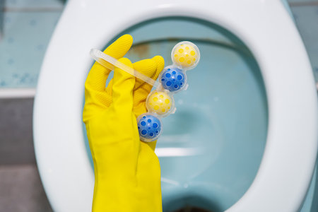 A yellow-blue plastic toilet block that cleans the walls of the toilet and refreshes the bathroomの写真素材