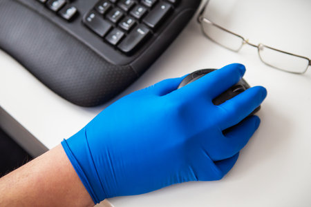 A doctor in blue gloves quickly collects data about a patient. The concept of healthcare and taking care of your health. Workplace of a doctor, online consultationの写真素材