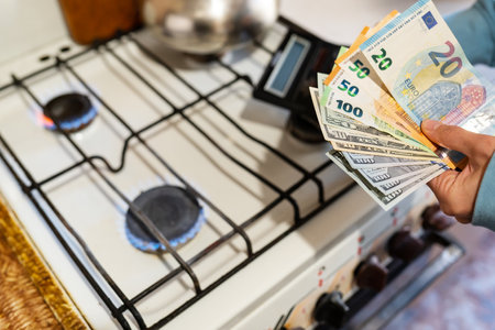The family calculates gas and utility bills. Euro and dollar bills in hands. The concept of increasing the cost of natural gas supply and payment. energy crisis. High cost, the price of gasの写真素材