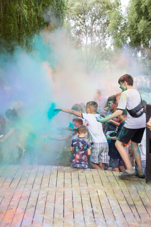 Lviv, Ukraine - July 18, 2021: Color Holi Festival, a crowd of people adults and small children throw colorful paint. Indian holidayのeditorial素材