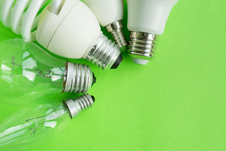 A set of different types of LED lamps isolated on a green background. energy-saving lampsの写真素材