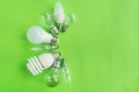 A set of different types of LED lamps isolated on a green background. energy-saving lampsの写真素材