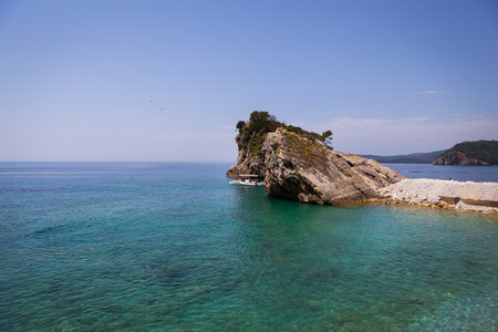 Very beautiful view of the sea and the rock, a small boat near the cliff, aquamarine clear water. enjoy the view. Montenegroの写真素材