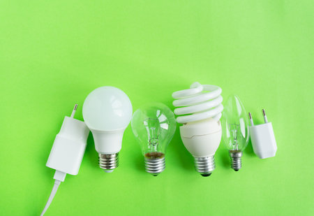 A set of different types of LED lamps isolated on a green background. energy-saving lampsの写真素材