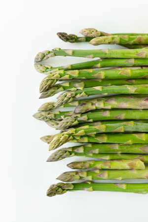 Fresh sliced asparagus plant on white background. top view. Vegan healthy foodの写真素材
