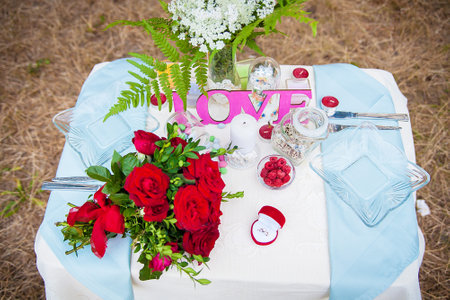 wedding table setting in nature. Bridal bouquet and ring.の写真素材